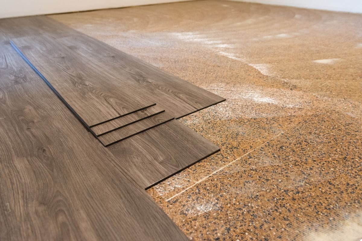 A wooden floor showcasing rich textures and warm tones, creating a cozy and inviting atmosphere in the space.